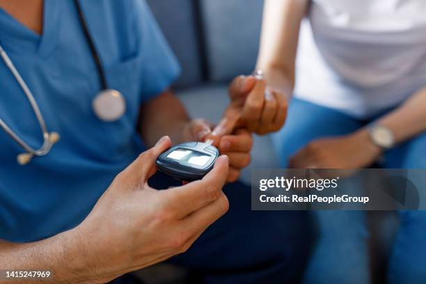 using a glucose meter - diabetes patient stock pictures, royalty-free photos & images