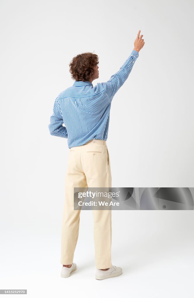 Man reaching up as if interacting with a touch screen