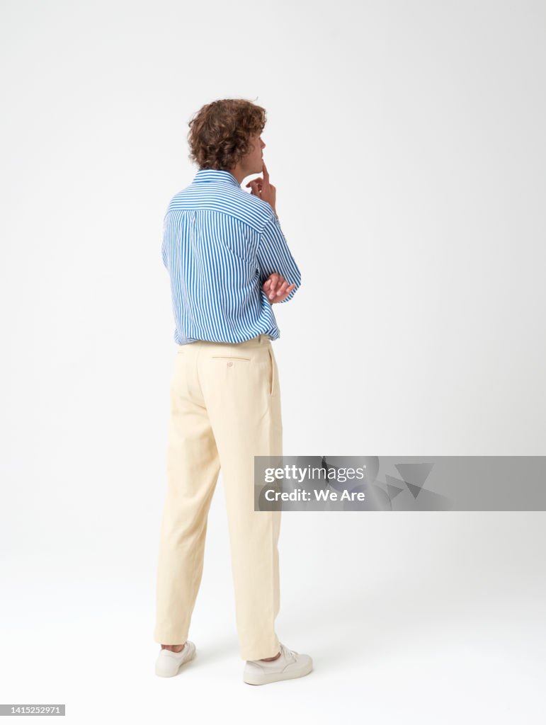 Man with back to camera contemplating a problem