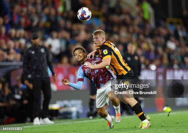 Manuel Benson of Burnley is challenged by Andy Cannon of Hull City during the Sky Bet Championship between Burnley and Hull City at Turf Moor on...