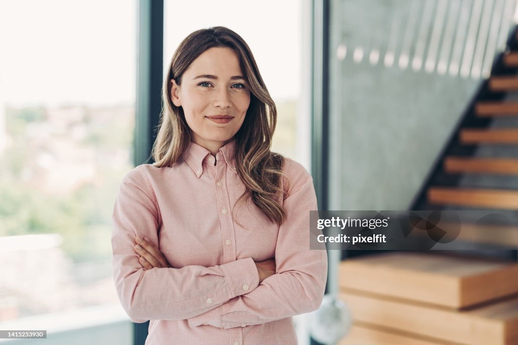 Businesswoman standing next to a staircase