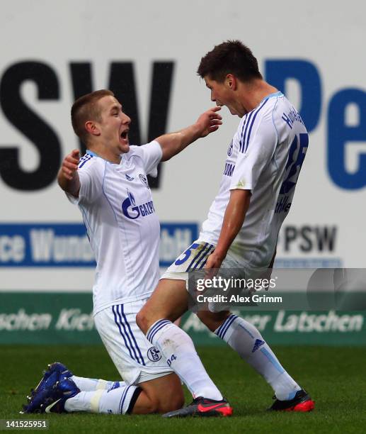 Klaas-Jan Huntelaar of Schalke celebrates his team's second goal with team mate Lewis Holtby during the Bundesliga match between 1. FC Kaiserslautern...