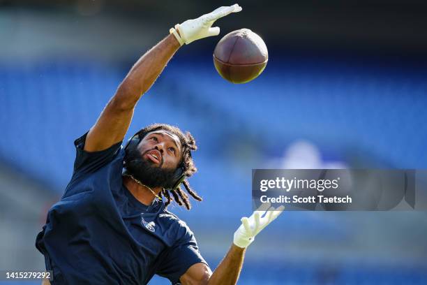 Josh Malone of the Tennessee Titans warms up before the game against the Baltimore Ravens at M&T Bank Stadium on August 11, 2022 in Baltimore,...