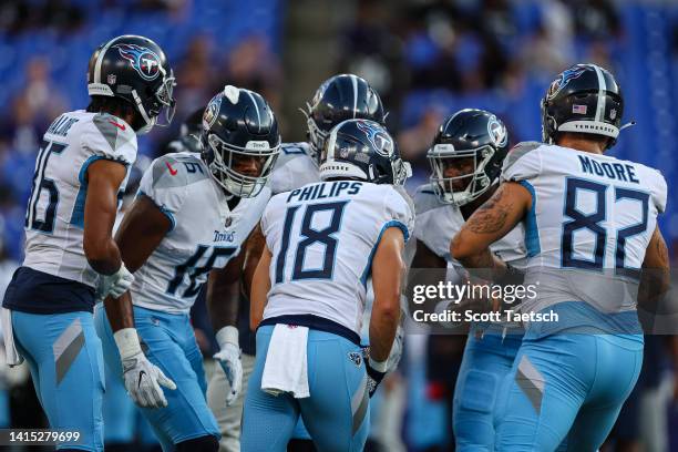 Malik Willis of the Tennessee Titans leads the offense in a huddle before the game against the Baltimore Ravens at M&T Bank Stadium on August 11,...