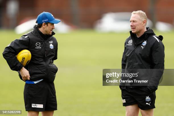 Assistant coach Jordan Russell speaks with Gavin Brown, Head of Development of the Kangaroos during a North Melbourne Kangaroos AFL training session...