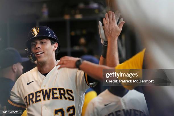 Christian Yelich of the Milwaukee Brewers celebrates in the dugout after hitting a solo home run against the Los Angeles Dodgers in the fifth inning...