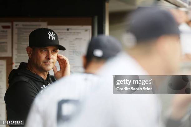 Manager Aaron Boone of the New York Yankees looks on from the dugout during the first inning against the Tampa Bay Rays at Yankee Stadium on August...