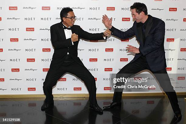 Actor Donnie Yen and actor Keanu Reeves joke around on the red carpet at the Power of Film Gala at the Grand Hyatt Hong Kong's Grand Ballroom on...