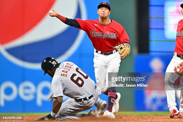Shortstop Tyler Freeman of the Cleveland Guardians turns a double play over Akil Baddoo of the Detroit Tigers at second base to end the top of the...