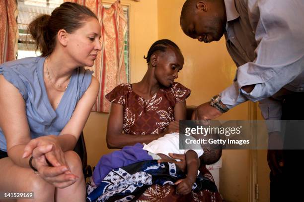 Dana Schweiger assists as a child gets vaccinated at the Entasopia health centre on March 7, 2012 iin Entasopia, in the remote southwest region of...