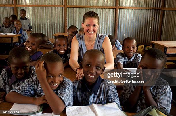 Dana Schweiger smiles in the company of children at a school on March 7, 2012 in Entasopia, in the remote southwest region of Kenya. Dana Schweiger...