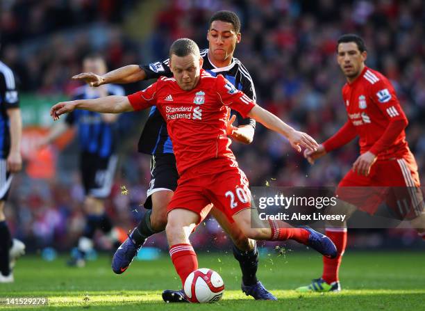 Jay Spearing of Liverpool is challenged by Ryan Shotton of Stoke City during the FA Cup with Budweiser Sixth Round match between Liverpool and Stoke...