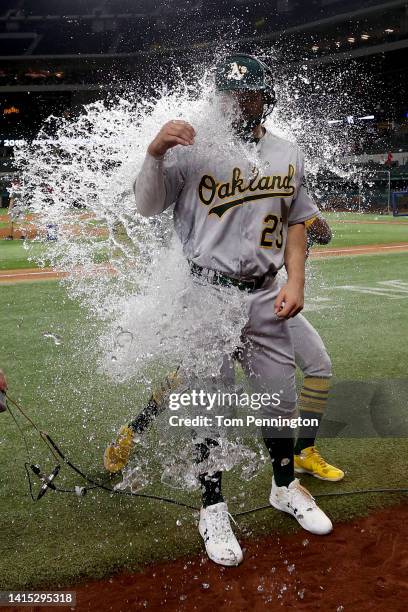 Shea Langeliers of the Oakland Athletics is soaked with the water cooler by Tony Kemp of the Oakland Athletics after his Major League debut against...