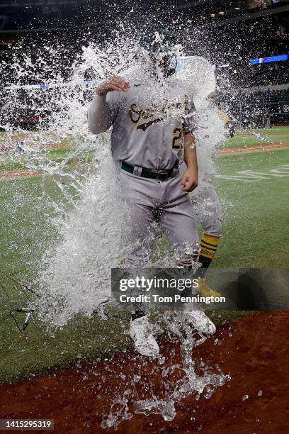 Shea Langeliers of the Oakland Athletics is soaked with the water cooler by Tony Kemp of the Oakland Athletics after his Major League debut against...