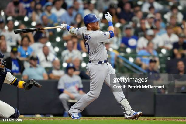 Justin Turner of the Los Angeles Dodgers hits an RBI single against the Milwaukee Brewers in the 11th inning at American Family Field on August 16,...