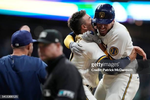 Victor Caratini of the Milwaukee Brewers celebrates with his teammates after hitting a walk-off two RBI single against the Los Angeles Dodgers in the...