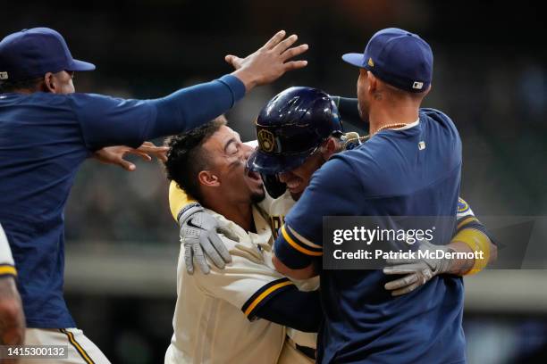 Victor Caratini of the Milwaukee Brewers celebrates with his teammates after hitting a walk-off two RBI single against the Los Angeles Dodgers in the...