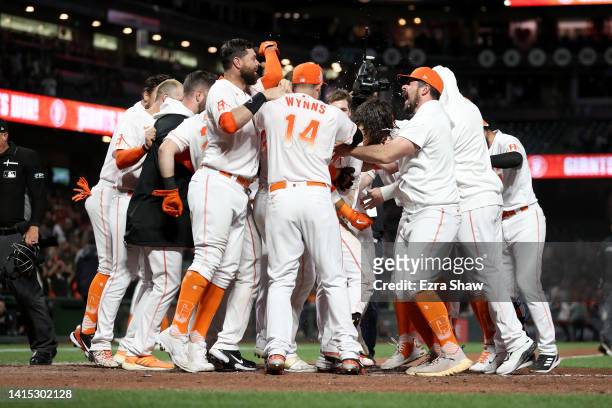 Brandon Crawford of the San Francisco Giants is congratulated by teammates after he hit a walk-off two-run home run in the bottom of the ninth inning...
