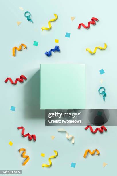 one plain box on confetti background. - confetti light blue background stock pictures, royalty-free photos & images