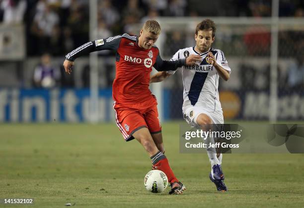 Nick Soolsma of the Toronto FC is pursued by Mike Magee of the Los Angeles Galaxy during a CONCACAF Champions League game at The Home Depot Center on...