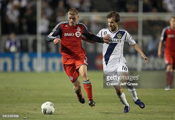 Nick Soolsma of the Toronto FC is pursued by Mike Magee of the Los Angeles Galaxy during a CONCACAF Champions League game at The Home Depot Center on...