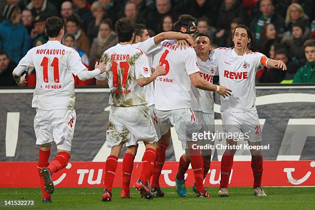 Kevin Pezzoni of Koeln celebrates the first goal with Milivoje Novakovic , Henrique Sereno , Slawomir Peszko and Pedro Geromel of Koeln during the...