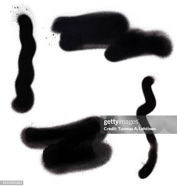 close-up of four black spray paint lines and shapes, isolated on white background. - sprühfarbe stock-fotos und bilder