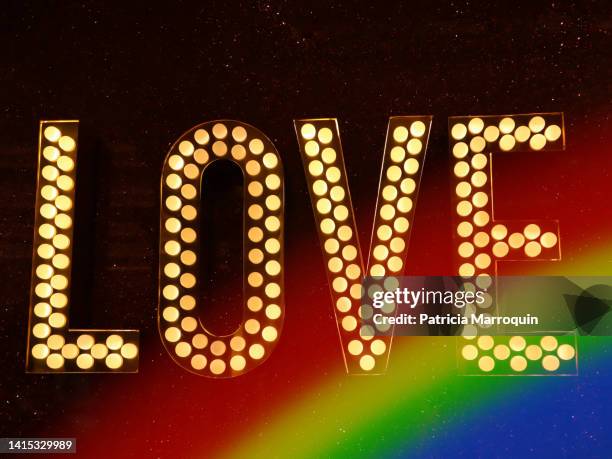 “love” in neon lights - marriage equality stock pictures, royalty-free photos & images