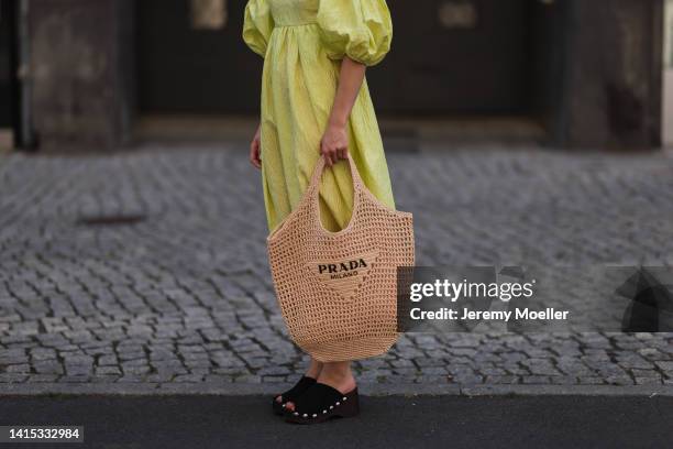 Lea Naumann seen wearing Cecilie Bahnsen neon yellow green long dress with puffer sleeves, Prada logo beige Raphia bast tote bag, Ganni black wood...