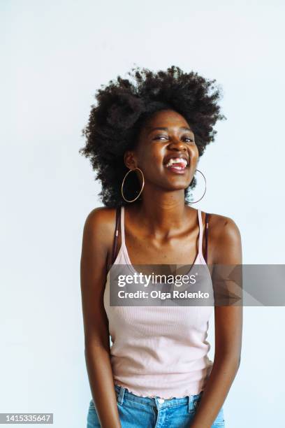 positive young woman laughing to camera - youth spirit - teased hair stock pictures, royalty-free photos & images