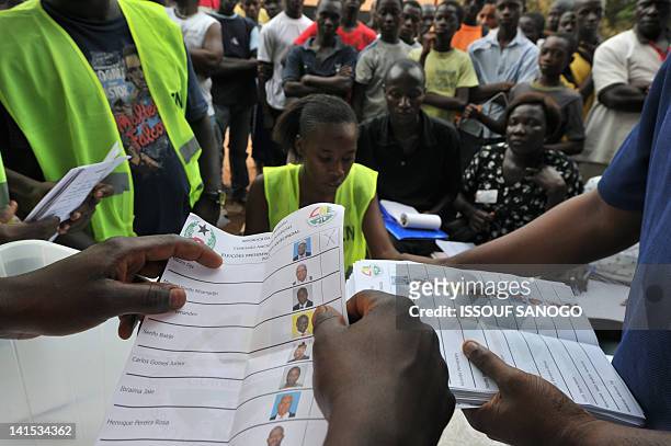 Electoral offciers count ballot papers at the polling station on March 18, 2012 in Bissau. Two leading presidential candidates criticised the...