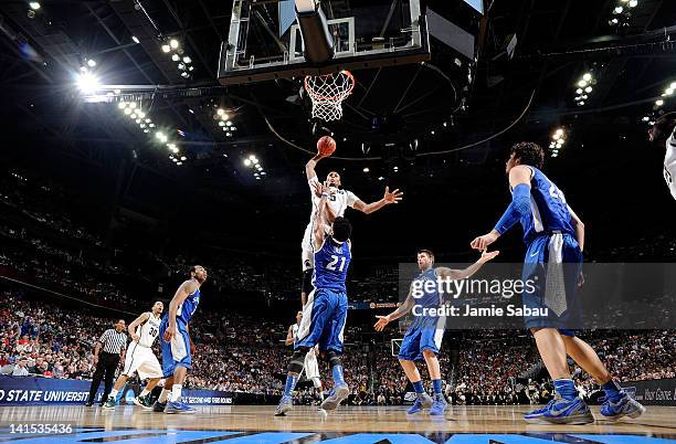 Adreian Payne of the Michigan State Spartans goes up for a dunk against Dwayne Evans of the St. Louis Billikens in the first half during the third...