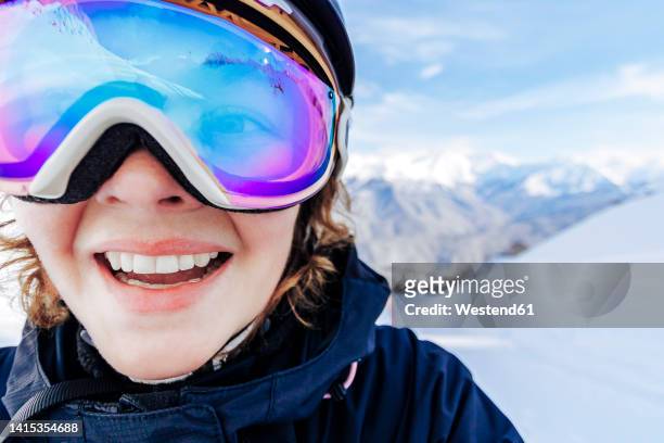 happy woman wearing ski goggles in winter - skiing helmet imagens e fotografias de stock