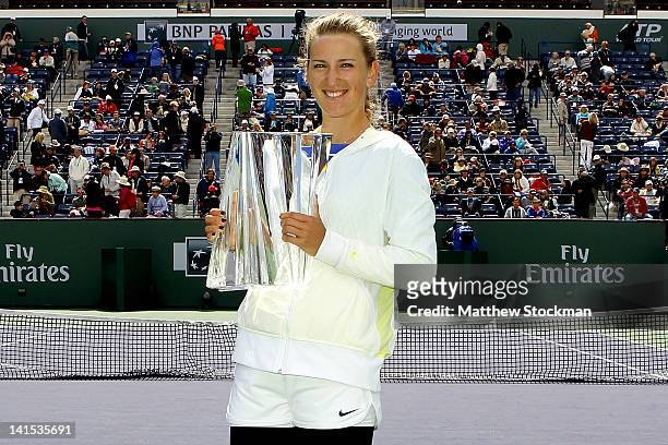 Victoria Azarenka of Belarus poses for photographers with the winner's trophy after defeating Maria Sharapova of Russia during the final of the BNP...
