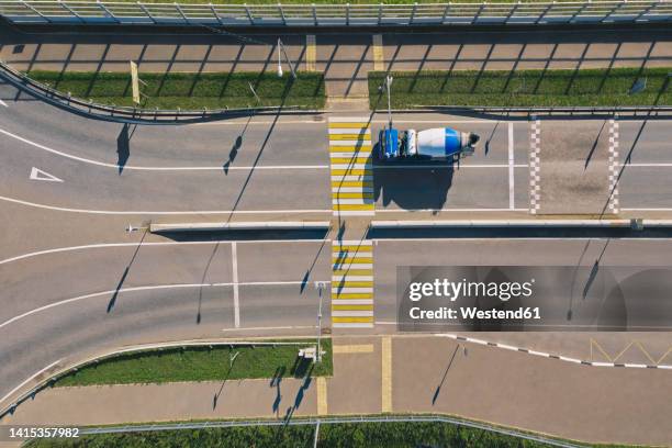 russia, aerial view of cement truck in front of empty zebra crossing - betonmischmaschine stock-fotos und bilder