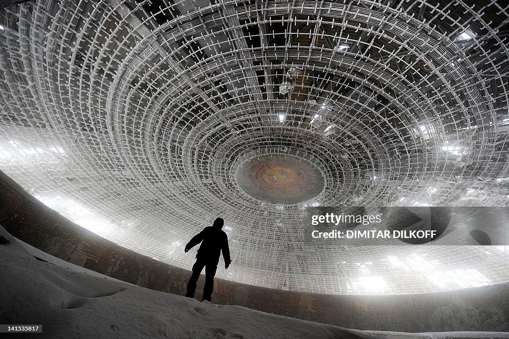 A man walks inside of the crumbling oval