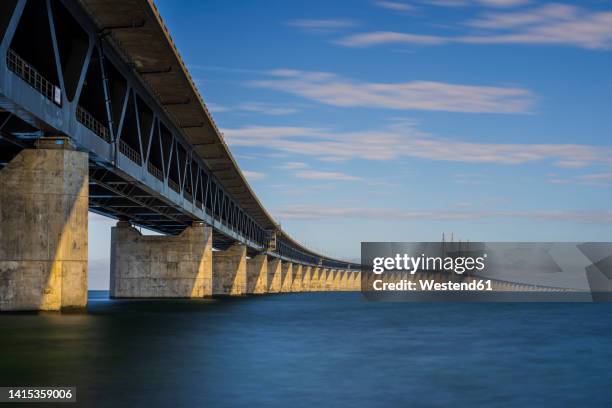 denmark, copenhagen, oresund bridge stretching overoresund strait - oresund bridge stock pictures, royalty-free photos & images