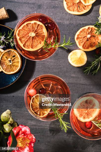 cranberry champagne cocktails garnished with orange and rosemary - dried food stock pictures, royalty-free photos & images