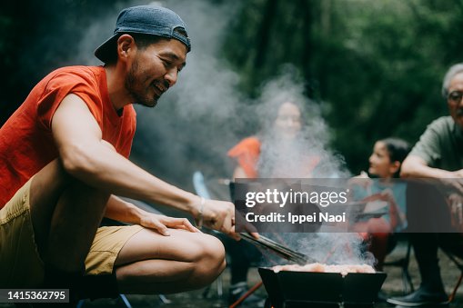 Man enjoying BBQ with family in nature Man enjoying BBQ with family in nature