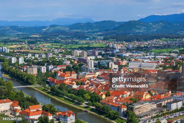 slovenia, savinja, celje, aerial view of riverside old town in summer with hills in background - celje foto e immagini stock