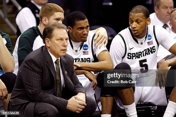 Brandan Kearney of the Michigan State Spartans sits on the bench speaking to head coach Tom Izzo after committing a foul against the St. Louis...