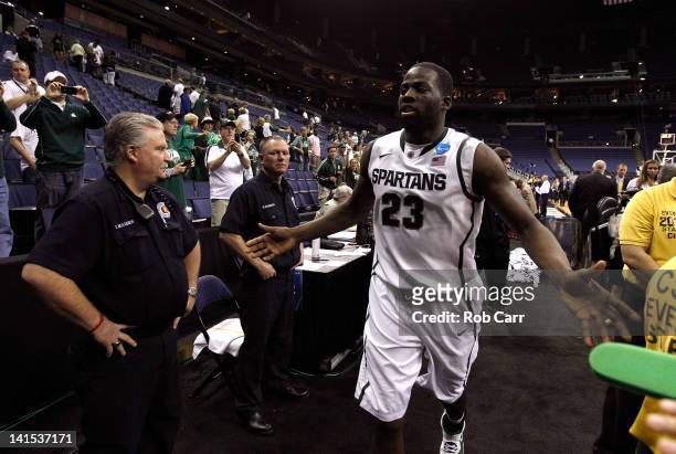 Draymond Green of the Michigan State Spartans high fives the crowd as he runs off the court after defeating the St. Louis Billikens during the third...