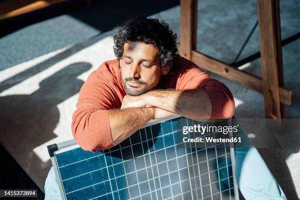 businessman with solar panel under sunlight in office - energía solar fotografías e imágenes de stock