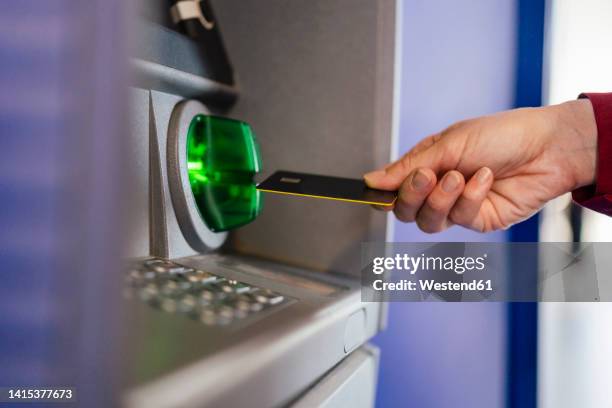 woman's hand using credit card at atm - inserts stock pictures, royalty-free photos & images