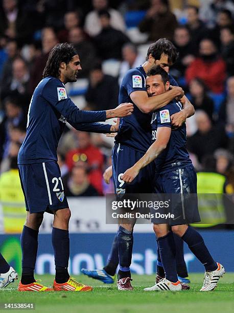 Santiago Cazorla of Malaga celebrates with Sergio Sanchez and Ruud van Nistelrooyafter scoring the equalising goal during the La Liga match between...