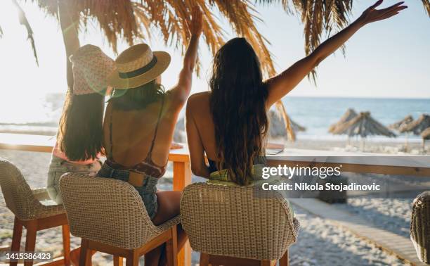 friends in a bar on the beach - hawaii model stock pictures, royalty-free photos & images