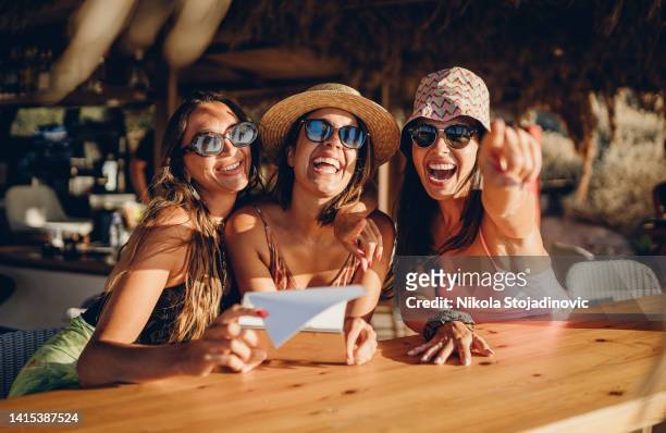 girls having fun cheering with cocktails at bar on the beach - ibiza party stock pictures, royalty-free photos & images