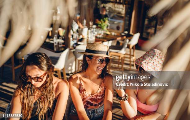 three friends in a summer bar - cocktails beach stock pictures, royalty-free photos & images