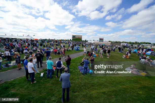 Racegoers watch from the Clock Tower Enclosure at York Racecourse on August 17, 2022 in York, England.