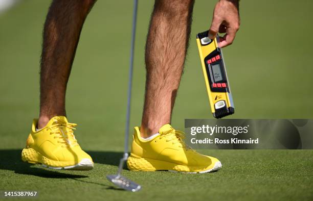 Joel Stalter of France with colour coordinated shoes and spirit level on the practice putting green during the pro-am event prior to the D+D Real...